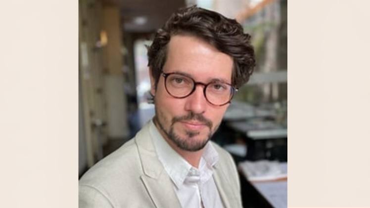 Full haired academic with glasses and well kept beard